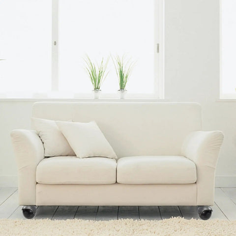 Up Your Game With These Old School Antique Brass Furniture Casters That Roll Like Butter on white sofa with cushions.