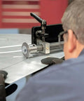 Man using Pro Grade Bead Roller Tipping Die Set With Polyurethane Wheel For Sheet Metal Forming CR12 Steel Dies on metal sheet