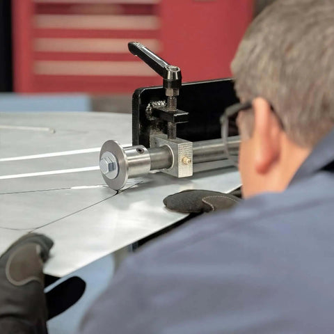 Man using Pro Grade Bead Roller Tipping Die Set With Polyurethane Wheel For Sheet Metal Forming CR12 Steel Dies on metal sheet