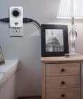 2 Pack Indoor 24 Hour Daily Repeat Timer With Two Grounded Outlets And No Sweat Plug And Play Setting For Home Lighting Small Appliances Holiday Decor Plus Laid Back Daily Automation Featuring A Solid 15 Amp Ul Rated Build installed next to a lamp and photo frame.