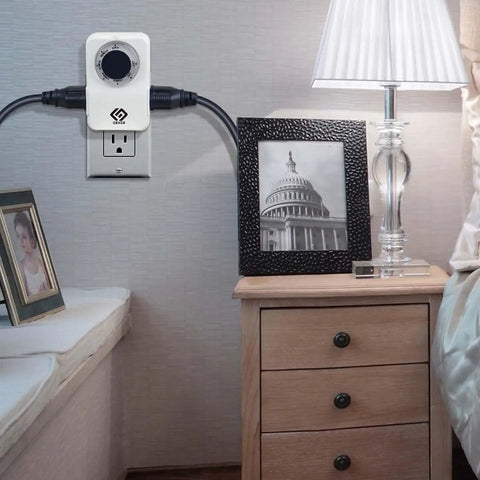 2 Pack Indoor 24 Hour Daily Repeat Timer With Two Grounded Outlets And No Sweat Plug And Play Setting For Home Lighting Small Appliances Holiday Decor Plus Laid Back Daily Automation Featuring A Solid 15 Amp Ul Rated Build installed next to a lamp and photo frame.