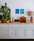 25 Pack Solid 5 Inch Square Kitchen Cabinet Handles in Brushed Nickel Pulls installed on white cabinet in modern setting
