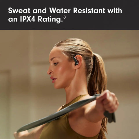 Woman using Powerbeats Pro 2 Wireless Noise Canceling Workout Earbuds during exercise, showcasing secure fit earhooks.