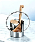 Heavy Duty Stainless Steel Kitchen Utensil Holder And Countertop Caddy Game Changer with wooden spoon on marble surface.