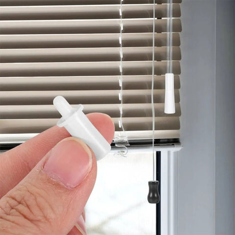 Close-up of a hand holding an 80 Piece Window Shutter Repair Pin from the Plastic Louver Hardware Kit.