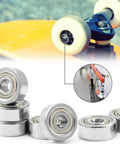 30Pcs 693ZZ Ball Bearings, High Speed Silent Small Bearing Deep Groove Double Shield Bearing Miniature Carbon Steel Bearings (3mm x 8mm x 4 mm) next to skateboard wheel.