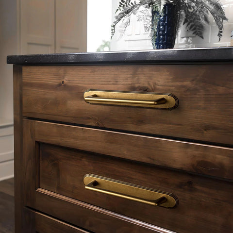 Antique Brass Cabinet Pulls With Backplate Zinc Alloy Retro Style Hardware With Classic Ornate Look And Comfortable Grip, installed on wooden dresser, close-up view.
