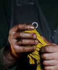 M10 Wedge Locking Washers Heavy Duty Manganese Steel Anti Vibration Safety Lock Hardware For Screws And Bolts Fastener Pack held in hand with yellow cloth.