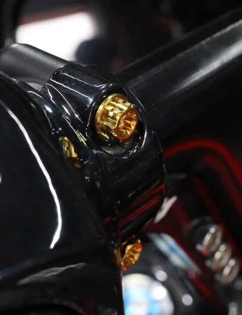Close-up of Top Shelf Titanium Handlebar Clamp Bolts And Brake Clutch Perch Screws For Heavy Duty Motorcycles on a motorcycle handlebar.