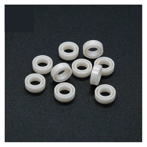 Premium Full Ceramic Ball Bearings Abec 9 Precision Sealed Zirconium Oxide 4MM 7MM 2.5MM shown in white on a black background.