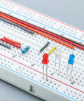 Three Pack Jumper Wires And Three Solderless Breadboard Sets With 830 Tie Point Breadboards showing color-coded jumpers and LEDs