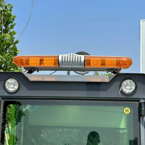 Heavy Duty Industrial Sweeper Machine with orange warning lights and reflectors on the roof for safety in warehouses.