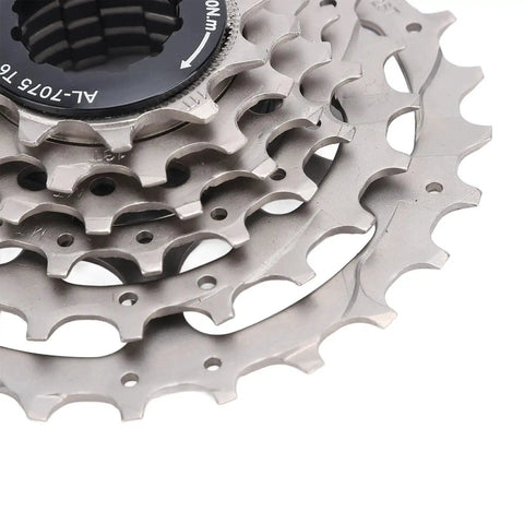 Close-up of six-speed bike freewheel cassette with hollow design, threaded type, large sprockets.