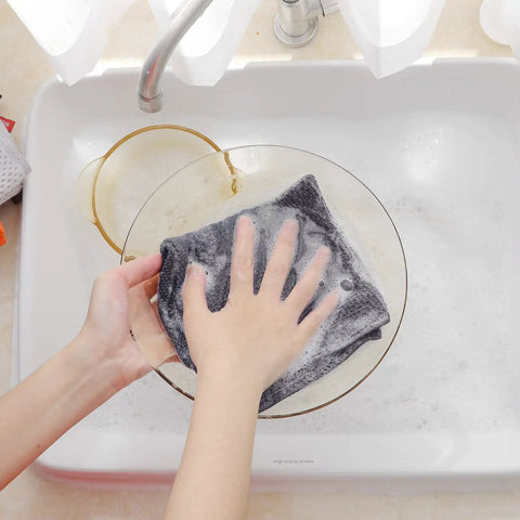 100 Percent Pure Cotton Waffle Weave Dish Cloths 6 Pack Dark Grey being used to wash a glass bowl in soapy water.
