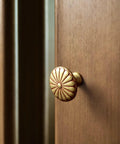 6 Pack Amber Red Cabinet Knobs 1.3 Inch Zinc Alloy Drawer Pulls Featuring Floral Radiating Texture Retro Hardware on wooden cabinet