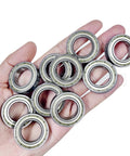 10 Pack 6700 Zz Miniature Ball Bearings 10X15X4Mm shown in hand, double metal shielded, chrome steel components for RC use.