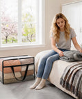 Woman arranging bedding using Roomy Clear Storage Sacks, Heavy Duty 60L Zippered Packing Bags For Seasonal Clothes And Bedding.