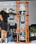 Deluxe Cold Brew Coffee Maker With Adjustable Drip Valve And Rustic Wood Glass Tower Designed For Ultra Smooth Iced Coffee 3000ML Capacity on display.