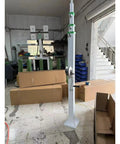 Heavy Duty 30 Foot Telescoping Mast With Manual Hydraulic Electric Lift Options Stainless Steel Construction standing in a workshop.