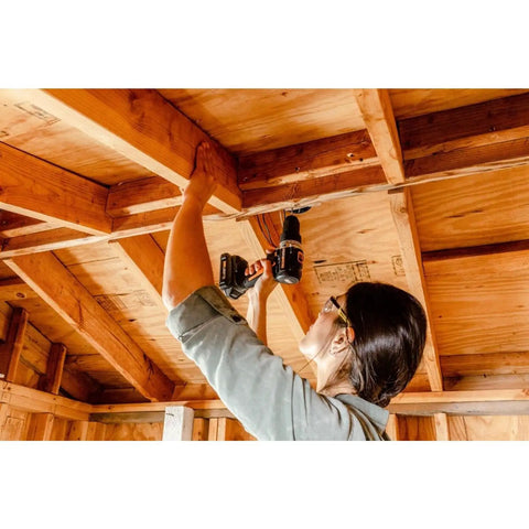 Compact 1/2 Inch 20V Cordless Drill Driver Featuring Brushless Motor And Adjustable Torque Settings used for ceiling framing work.