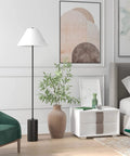 64 Inch Tall Floor Lamp With White Fabric Empire Shade In Blackened Bronze Finish next to nightstand in modern bedroom