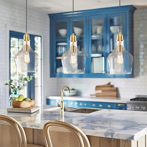 Hand Blown Glass Bell Pendant Light in Gold and Clear, Industrial Farmhouse Style, 9 Inch Shade over a kitchen island.