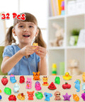 A girl smiling while holding a yellow mochi squishy toy among a colorful assortment of 32 pieces from the Premium Total Knockout 32 Pack Mochi Squishy Toys Kawaii Animals Slow Rising Party Favors And Goodie Bag Stuffers Dope Birthday Gifts Stress Relief Sensory Fidget Fun.