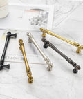Slick Antique Brass Cabinet Pulls 10 Pack, 5 Inch solid metal handles in various finishes on a marble surface.
