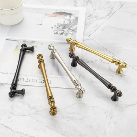 Slick Antique Brass Cabinet Pulls 10 Pack, 5 Inch solid metal handles in various finishes on a marble surface.