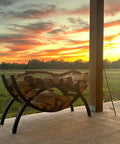 3 Foot Crescent Firewood Rack Heavy Duty Indoor Outdoor Steel Log Holder With Black Powder Coat Finish on patio at sunset