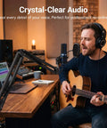 Solid Quality USB Computer Microphone For Podcasting Gaming And Streaming Delivers Crisp Broadcast Audio With Cardioid Polar Pattern Background Noise Isolation Plug And Play Works Like A Charm On Windows PCs in a recording studio with a man singing and playing acoustic guitar.