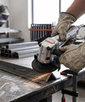 Battle Tested 4 Inch Pneumatic Angle Grinder Spits Out 11000 Rpm cutting metal with sparks flying, ergonomic grip in workshop.