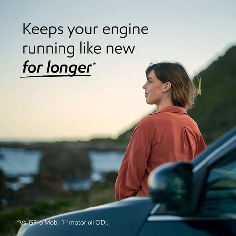 Woman standing beside a car with the ocean in the background, promoting Top Shelf Full Synthetic Motor Oil 0W20 Five Quint Container.