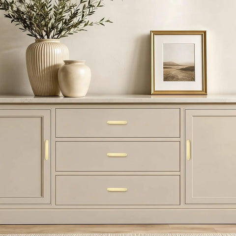 Heavy Duty Thirty Pack Cabinet Pulls And Kitchen Drawer Handles Cast In Rich Brushed Brass With A Precise Five Inch Spread, displayed on a sideboard.