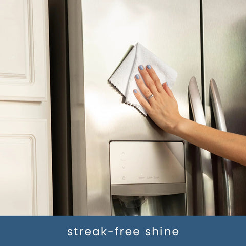 S&T INC. 50-pack white microfiber cleaning cloths; front view of hand wiping a stainless steel refrigerator.