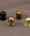 Antique Brass Cabinet Knobs 30 Pack Set For Vintage Drawer Pulls showcasing different finishes on a textured surface.