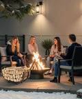 People sitting by a fire pit with 24 Inch Indoor Firewood Rack With Carrier, Thickened Metal Rustproof Wood Storage Rack nearby.
