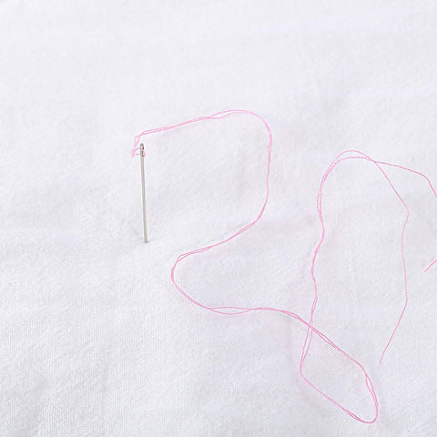 Close-up of pink thread in a needle from Two Box Set Pre Threaded Needle Kit With Twenty Pieces And Mixed Color Threads 32 Inch Length