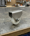 Heavy Duty Double Hole Bracket Pulley With Nylon Wheel Track Roller And Sealed Bearing Axle on wooden surface, showcasing sturdy design.