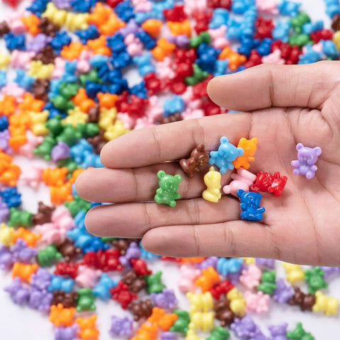 Super Cool Rainbow Counting Bears Set With Nine Rad Colors Perfect For Toddler Math Manipulatives And Preschool Activities in a hand.