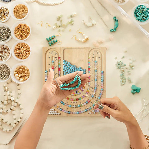 Person using Bamboo Bead Board for Jewelry Making With 3 U Shaped Grooves And 4 Storage Slots for necklace and bracelet crafting.