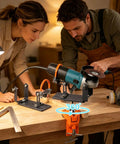 Adjustable Angle Grinder Holder with a Savage Grip Vise Base for Crushing Grinding Jobs and Polishing Tasks Featuring 360 Degree Swivel Action and Benchtop Mount being used by two people.