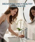 Woman using Waterfall Style Brushed Nickel One Hole Bathroom Sink Faucet With Pop Up Drain And Supply Lines, 3 Hole Compatible