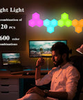 Hexagonal Wall Light Kit With Modular Touch Sensing Panels Dope 10 Pack LED Geometric Wall Lamps For Living Rooms And Bedrooms Remote Controlled Color Changing LEDs 13 Monochrome Modes USB Powered DIY Friendly displayed in a home office