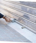 Installation of Badass Hurricane Shutter Hardware Plus Window Shutter Stopper Kit featuring light gray roller bumpers.