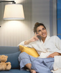 Relaxed woman on sofa under Fully Dimmable Arc Floor Lamp With 1000 Lumens LED Edison Bulb Included Modern Tall Standing Lamp