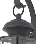 Close-up of the Newbury 14 Inch Outdoor Wall Lantern in Mystic Black With Clear Beveled Glass, Classic French Country Style with brass detail.