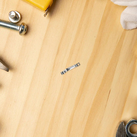 Rock Solid Metal Push Button Spring Clip For Zero Hassle Umbrella Repair and Patio Sun Shade Replacement on wooden surface.