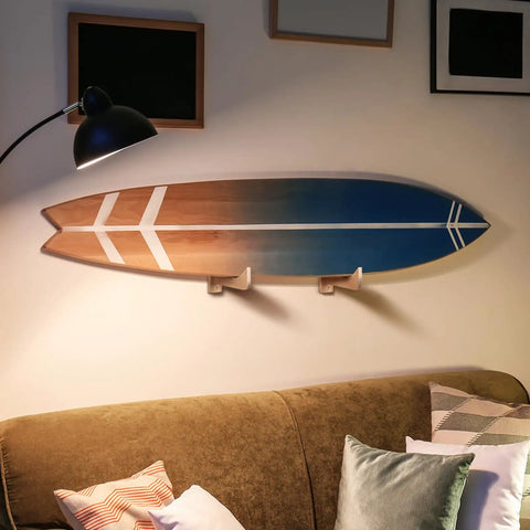 4 Piece Ash Wood Surfboard Wall Mount Kit With Curved Wave Grip To Hang Your Board Horizontally On Garage Or Studio Walls For Tight Surf Vibes And Gnarly Collection Display mounted above green couch.