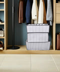 Total Closet Game Changer 3 Pack Seven Grid Foldable Bins With Grippy Handles organizing socks and pants in a closet.
